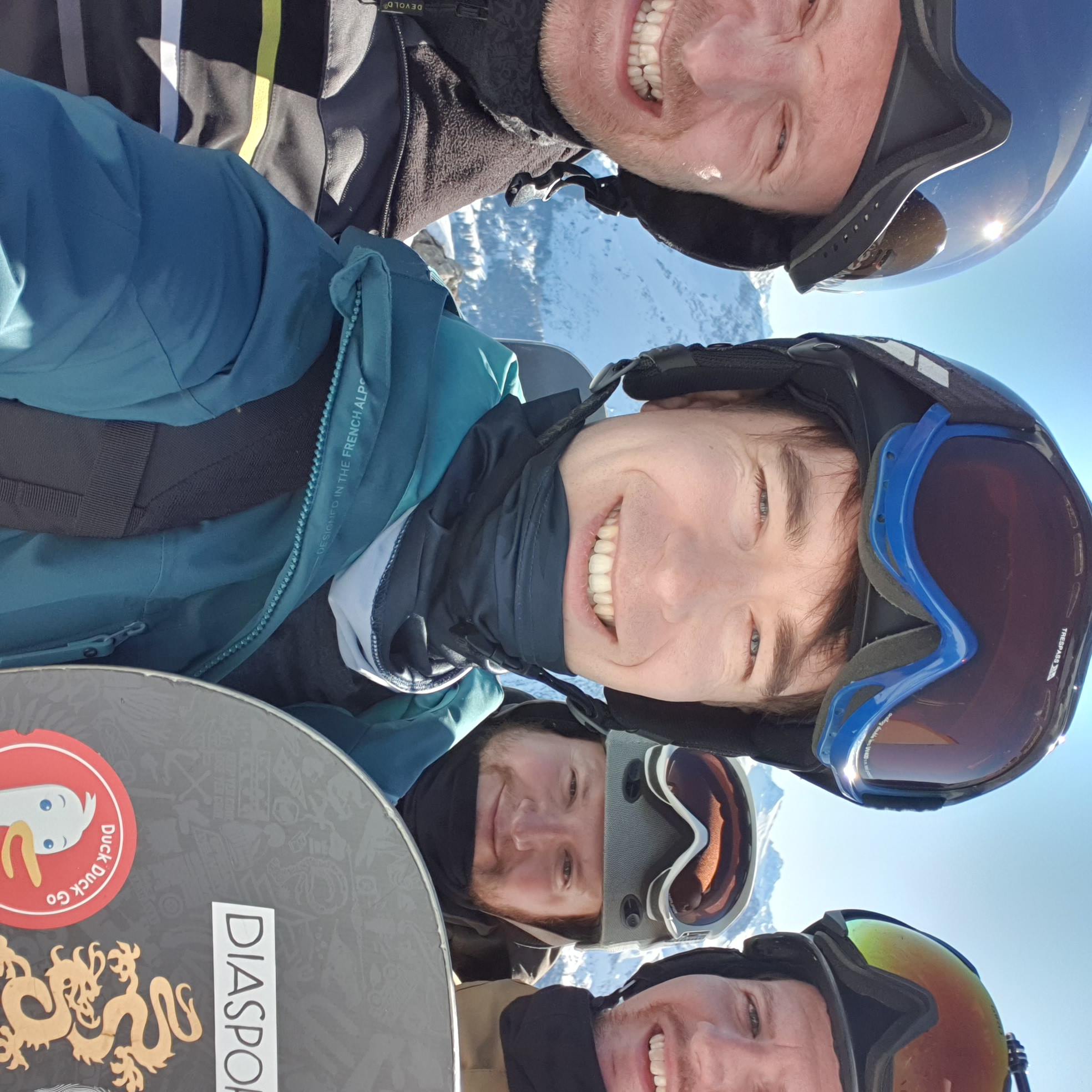 group photo with people dressed in ski gear on a sunnyday